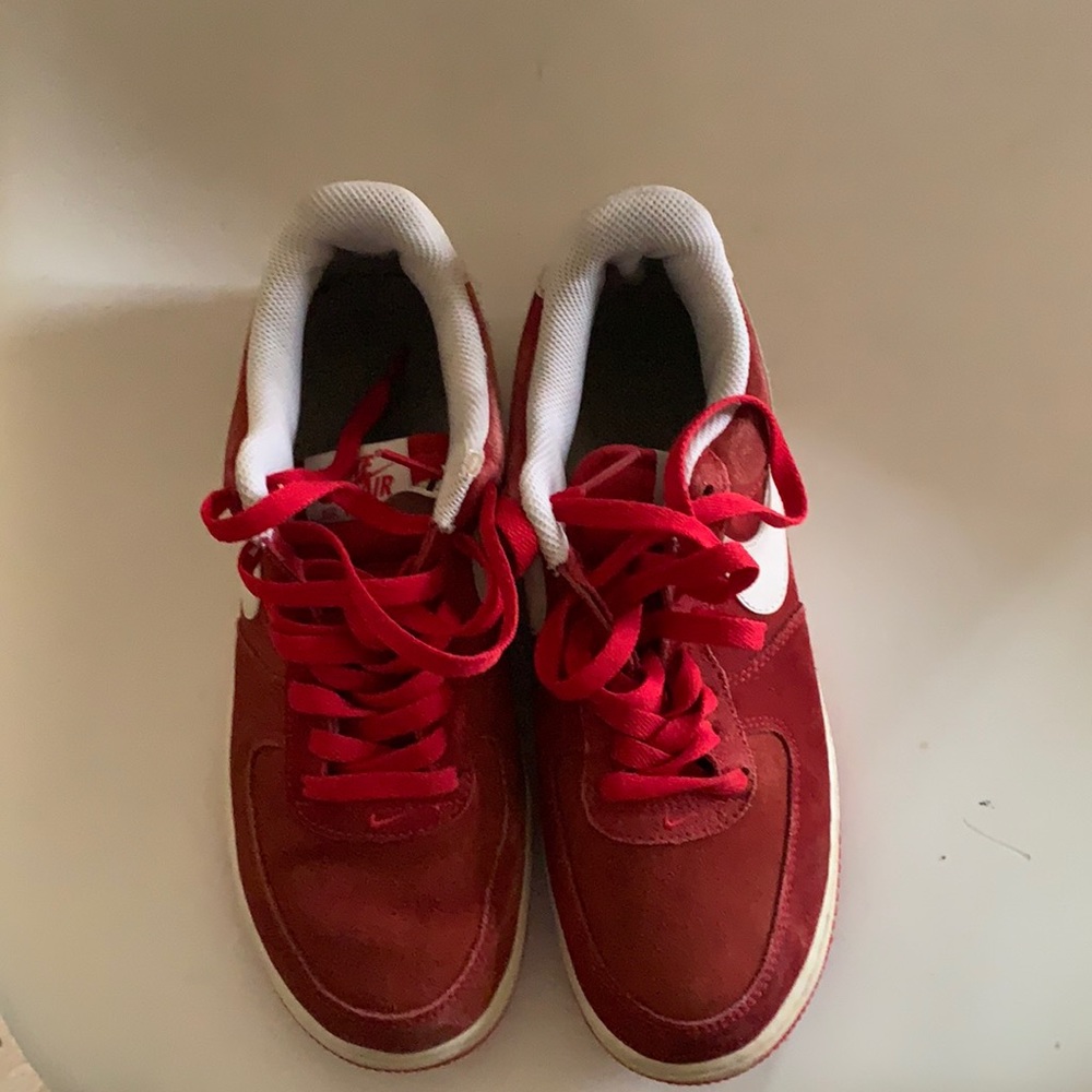 Red and white Nike Air Force low tops